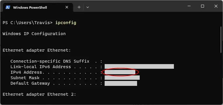 A screenshot of Windows PowerShell. The command ipconfig has been executed.
Redacted information is shown. A red annotation circle surrounds the redacted
value for IPv4 Address.