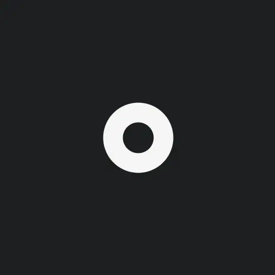A small circle with a thick white outline and no fill on a dark
background