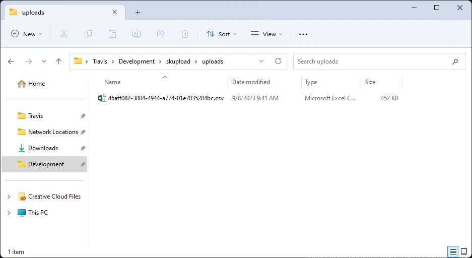 The file explorer in Windows. It is open to a directory called uploads. A
CSV file with a random name (46aff082....csv) is
visible.