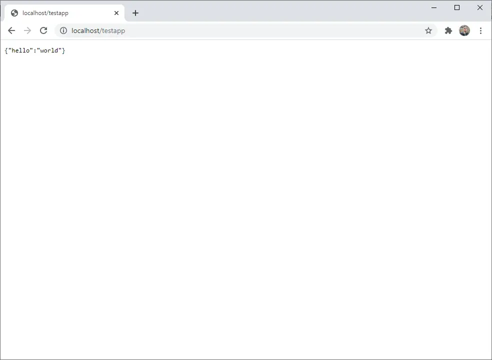 A Chrome web browser opened to localhost/testapp. The rendered page is black
text on a white background reading {"hello":
"world"}.